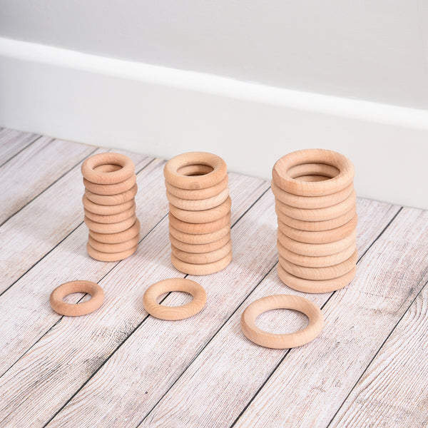 Beechwood Rings Pack of 10, Designed to open up a new world of discovery and play, this 56mm Pack of 10 Beechwood Rings is ideal for igniting the imagination in toddlers. Designed for heuristic play which is rooted in children's natural curiosity, these simple wooden Beechwood Rings create a treasure trove of play ideas that help to develop their playing and cognitive skills. Allow children to feel, pair, stack and loop these beechwood rings again and again and you'll help to develop an open environment whe