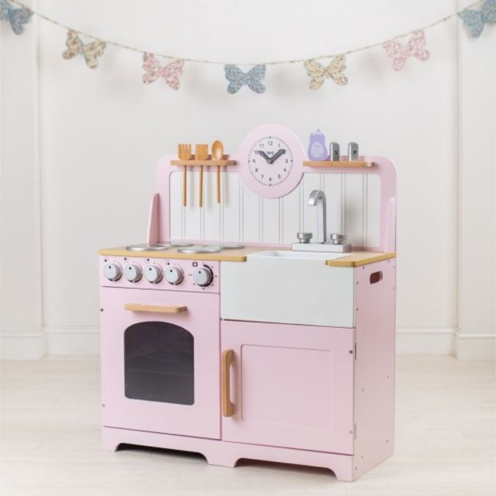 Bigjigs Tidlo Country Kitchen Pink, Inspire budding young chefs to cook up a storm with the delightful wooden Bigjigs Country Play Kitchen from Tidlo in Pink. This lifelike Pink Country Kitchen playset features an oven and hob with clicking dials, a storage cupboard, a Belfast sink, utensil shelves and a clock with moveable hands, to ensure dinner is served on time! Plus, three kitchen utensils which can be slotted tidily in the shelf above the hob, a plastic bowl in the sink, salt & pepper and washing up l