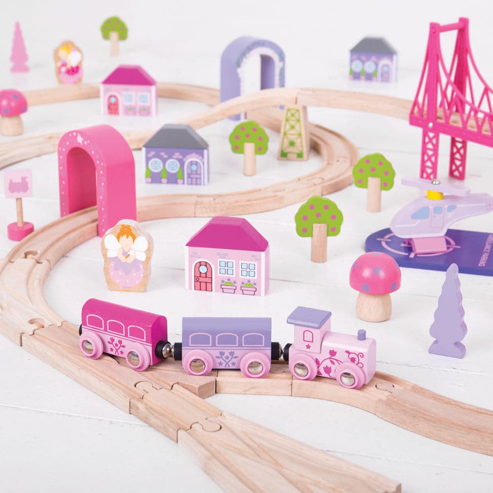 Fairy Town Train Set, A fantastic wooden train set with a sprinkle of fairy dust! The fairies have come to town and the Fairy Town Pink Train Set is ready to depart to a magical fairytale land far, far away. Pinks, pastels and fairy figures all take centre stage with this wonderful wooden train set. This wooden train set comes with 75 play pieces to ensure there’s no limit to imaginative play. From the fairy figures to the brightly coloured trees and houses, even the helicopter is colour coordinated to appe