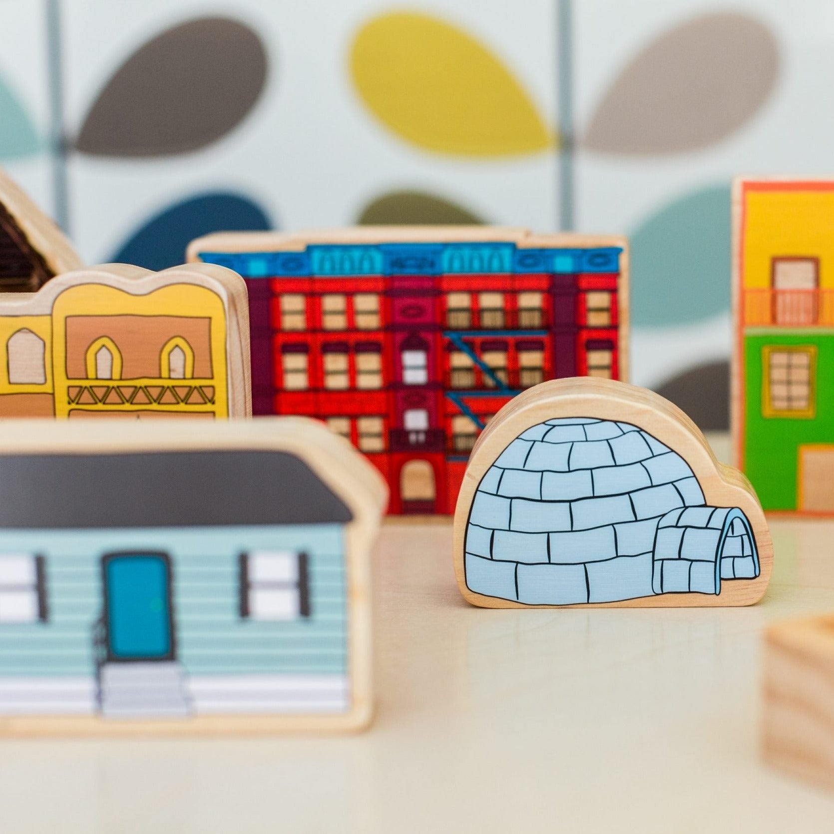 Homes Around the World, Introducing the Freckled Frog Homes around the World wooden block set - a beautifully illustrated and vibrant toy that sparks discussion about inclusion and communities while celebrating the diverse cultures and homes found around the globe. This set includes 15 blocks, each representing a different culture and country, such as Greece, Germany, South America,and China, among others.These wooden blocks are not only visually stunning but also serve as a tool for children's creative pla