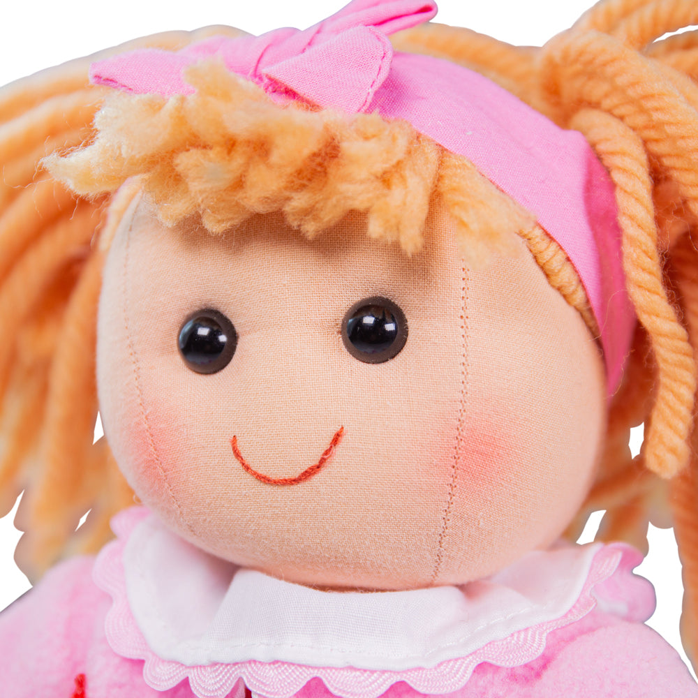 Kelly Doll - Medium, Introducing Kelly, the adorable and huggable doll that is ready to be your little one's newest best friend! With her charming pink dress and a matching cardigan, Kelly is the epitome of cuteness and style.Designed with attention to detail, this soft and cuddly doll will engage your child's imagination during playtime. Kelly's gentle expression and lovable features make her incredibly endearing, capturing the hearts of both kids and adults alike.Whether your little one wants to have a te