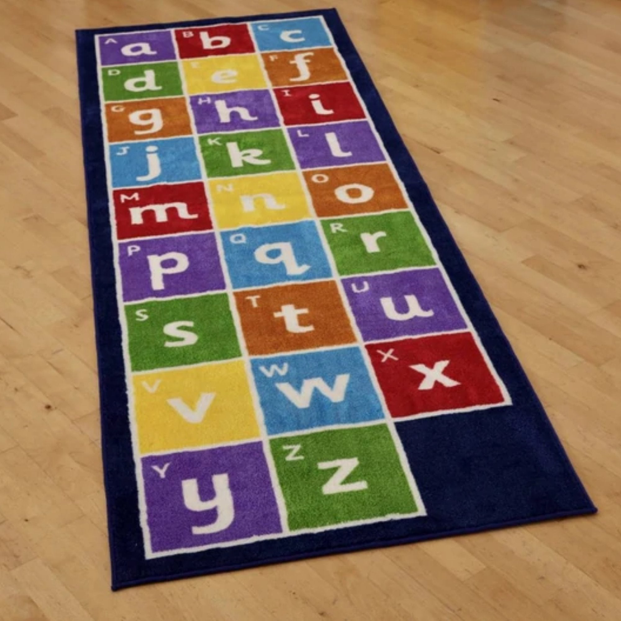 Kinder Alphabet Runner Carpet 3 X 1 Metre, This Kinder™Alphabet Runner Carpet measures to 3 x 1 metre, featuring the alphabet in both lowercase and uppercase. The Kinder™Alphabet Runner Carpet is a Heavy duty Dura-Pile™, a substantial premium quality carpet with an extra thick pile. The soft textured tufted Nylon twist pile is designed specifically for comfort and longevity. Tightly bound edges prevent fraying and the tuft strands meet heavy duty use. Ideal for Early Years and school learning environments w
