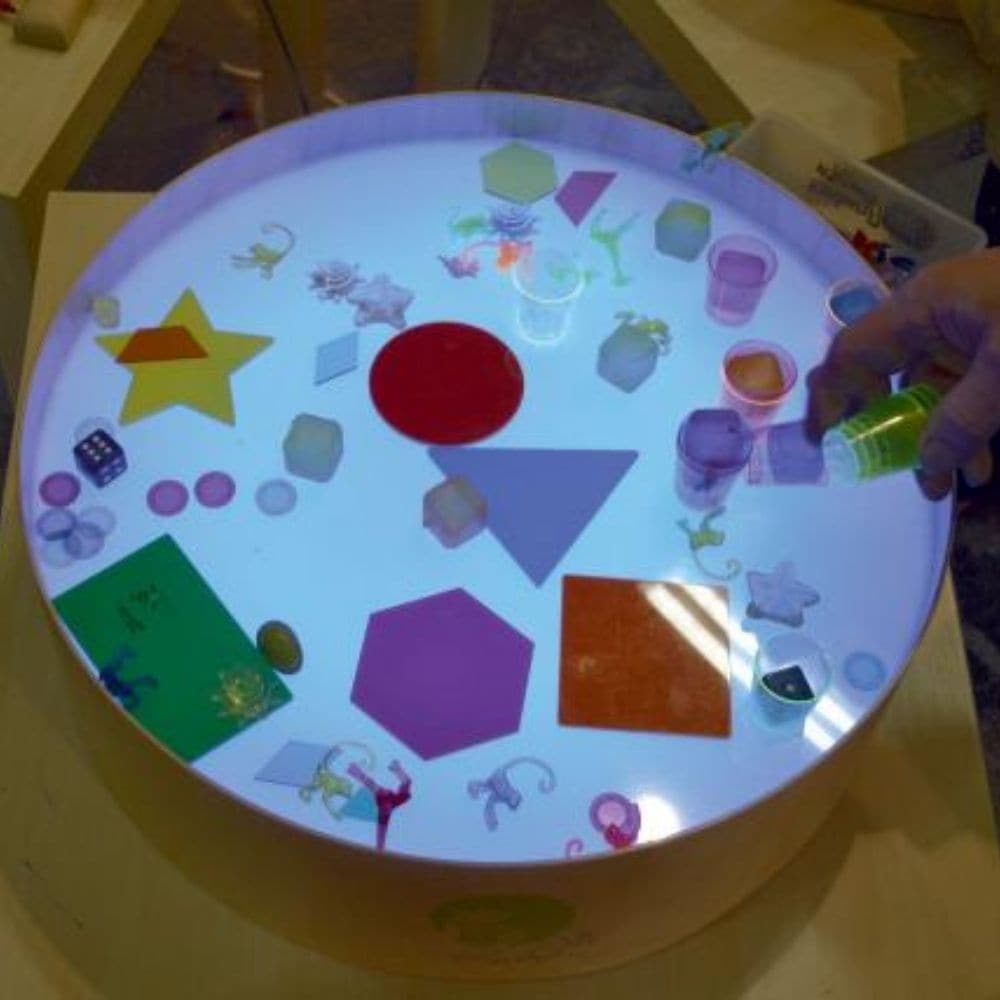 Magic Light Table, Magic light table is a small and lightweight table designed for games, art and therapy. The table has a higher edge preventing sand, semolina and other small elements used for creation from spilling. The light consisting of even 16 different colours and four different automatic colour change programs help create an impression of playfulness of the table. You can draw with your fingers, brushes and pads on the table. A special sand raker, air blown through the straw, foot or palm imprints 