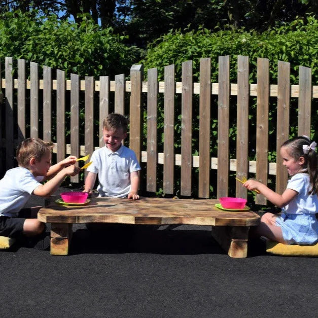 Outdoor Low Rustic Table, Enhance collaborative learning with our Outdoor Low Rustic Table! A versatile resource that can be used for both outdoor learning and eating lunch outdoors. Handmade in our Lincolnshire workshop, this rustic table was designed with adventure in mind. The idea is to create a comfy spot on the ground and gather around the table with friends for an adventurous lesson or picnic. Delivery 4-6 weeks, Delivered fully Assembled, FSC Pressure Treated Redwood Timber 10-year guarantee against