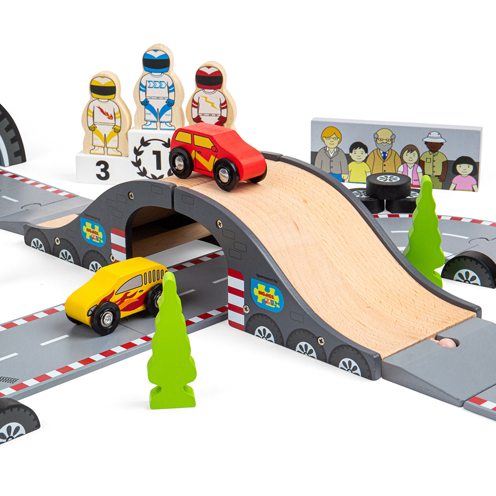 Roadway Race Day, On your marks, get set, go! Zoom around corners and race to the finish line with our brand new Race Track Toy Roadway. The perfect gift for little Formula 1 fanatics. Our impressive 47-piece wooden car track is packed with three race cars, three race car drivers, a male & female mechanic, a podium, and a grand stand stadium for spectators plus plenty of accessories such as barriers, traffic lights, flags, and cones. The race track features skid marks, oil spills and a pit stop. Great for i
