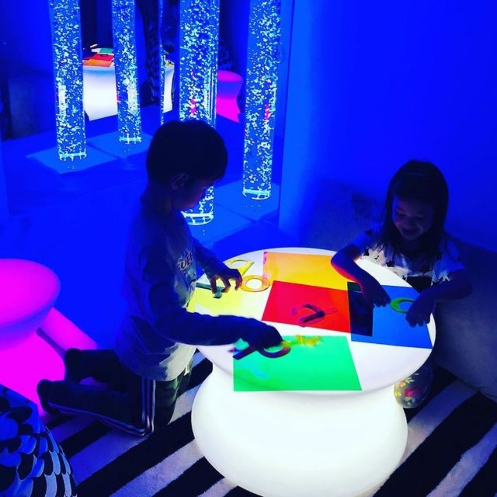 Sensory Mood Light Table, The ultra-strong illuminated Sensory Mood Light table is an aesthetically pleasing cotton reel shape, and can be placed around the room or used in a sensory den to provide a softly lit table unit. Using the Sensory Mood Light Table remote control you can choose one of 16 different colours or set to fade smoothly through the entire spectrum of shades from a cool ultra-violet to a warm red. The appearance of the Sensory Mood Light Table is mesmeric and the colour spreads evenly throu