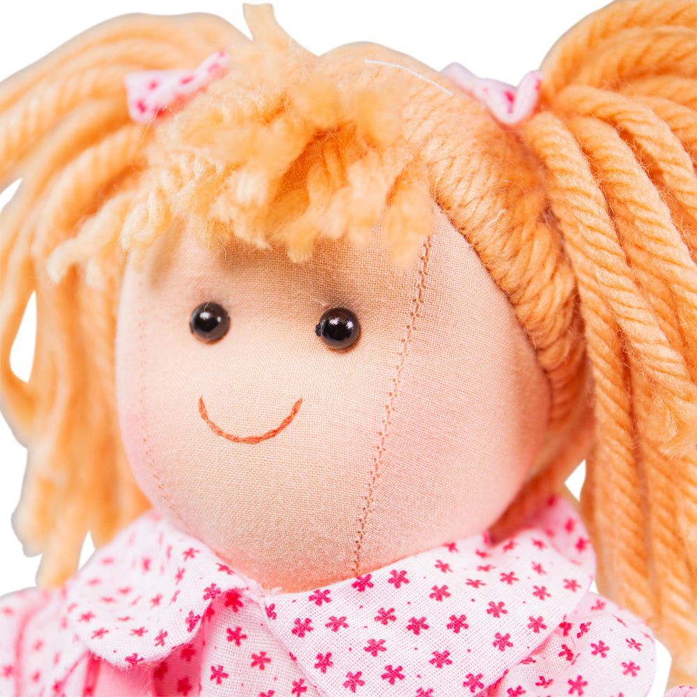 Sophie Doll - Small, Introducing Sophie, a soft and cuddly doll who is ready to be your little one's new best friend! With her warm hearted personality, Sophie is eager to share endless playtime fun and lots of comforting hugs.Sophie comes dressed in a smart pink polka dot dress that exudes style and charm. Her matching hair ribbons add a delightful touch, making her simply adorable! Your child will love dressing Sophie up in different outfits using the Bigjigs Toys Doll outfits, which are available separat
