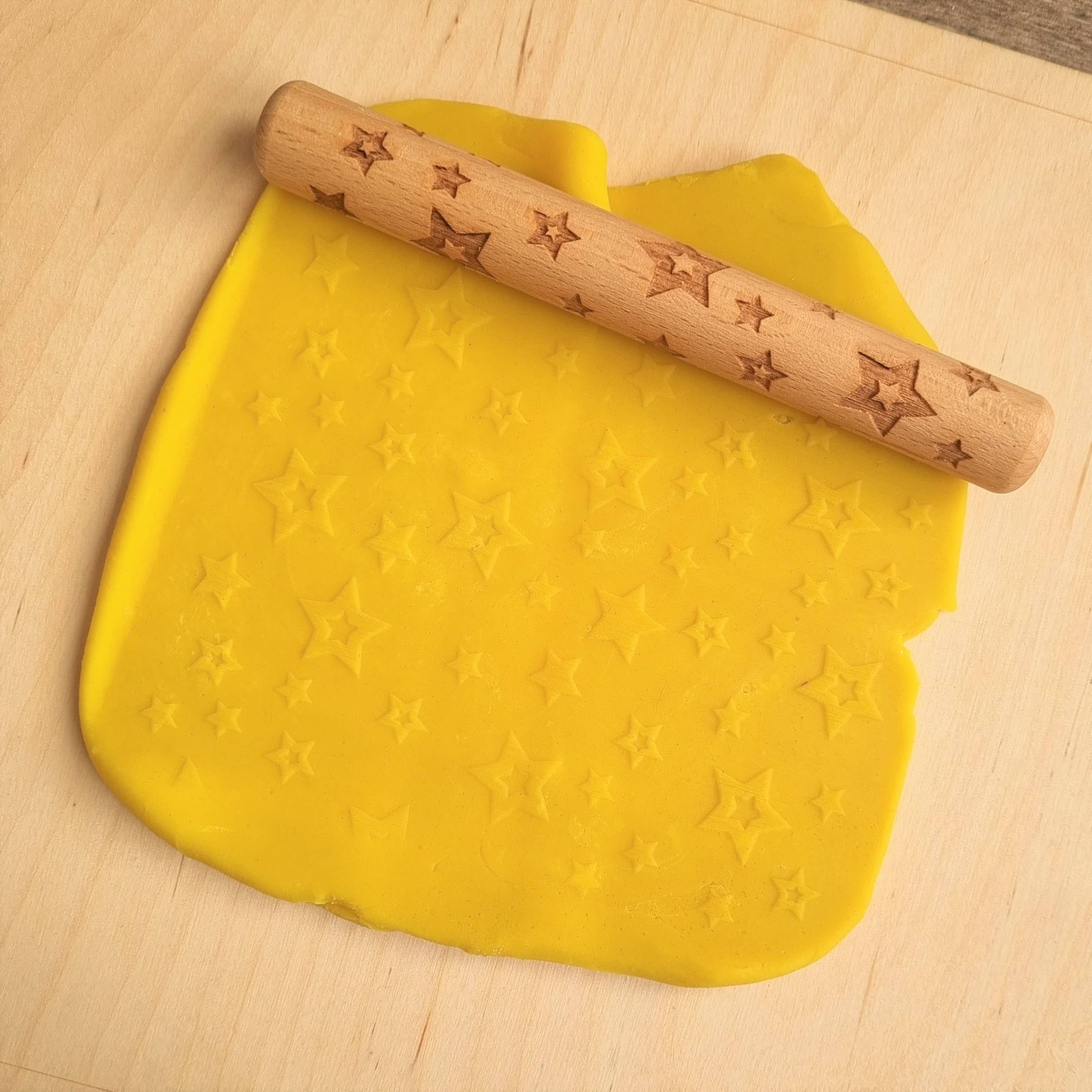 Stars Wooden Roller, Introducing our Stars Wooden Roller.This unique and charming roller is the perfect addition to your child's art and sensory playtime. Made from high-quality wood, this Stars Wooden Roller is designed to create texture and relief as your little ones roll out their clay creations. The Stars Wooden Roller features a fun star pattern, perfect for playful and imaginative minds. The rollers are 16 cm long and 2 cm in diameter The rollers are made of beech wood. If clay/dough remains in the ro