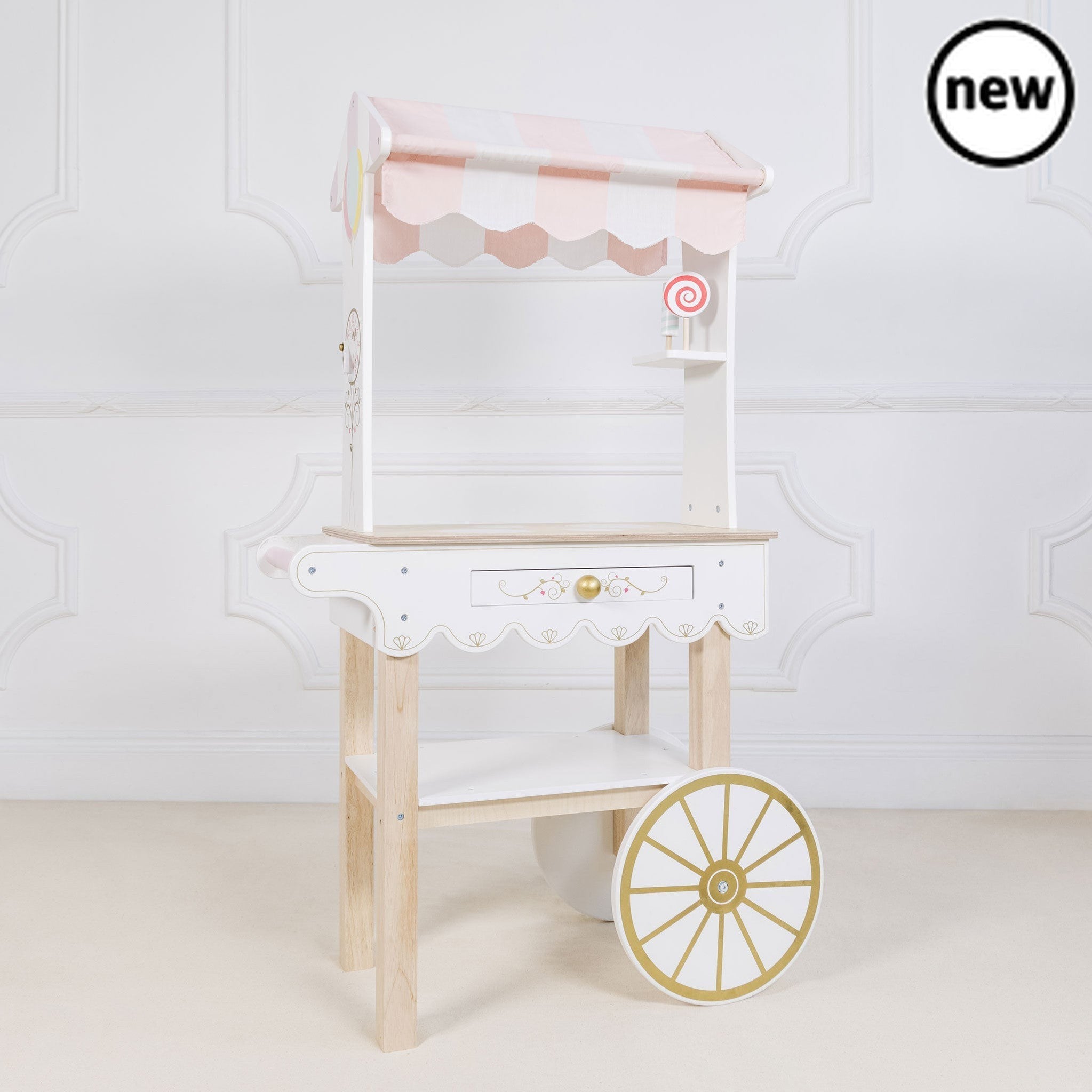 Tea & Treats Trolley, Description Time for Tea! This barrow style tea and treats trolley is a real head turner. It's stunning vintage style design makes it a real showstopper and a truly magical gift to treasure. The traditional candy striped fabric canopy really sets off this beautiful wooden toy. Complete with a secret drawer ,this classic trolley features two wheels and a handle for wheelie good fun. Adorned with delightful illustrations and a cake and beverage menu on both side panels. Painted in child 