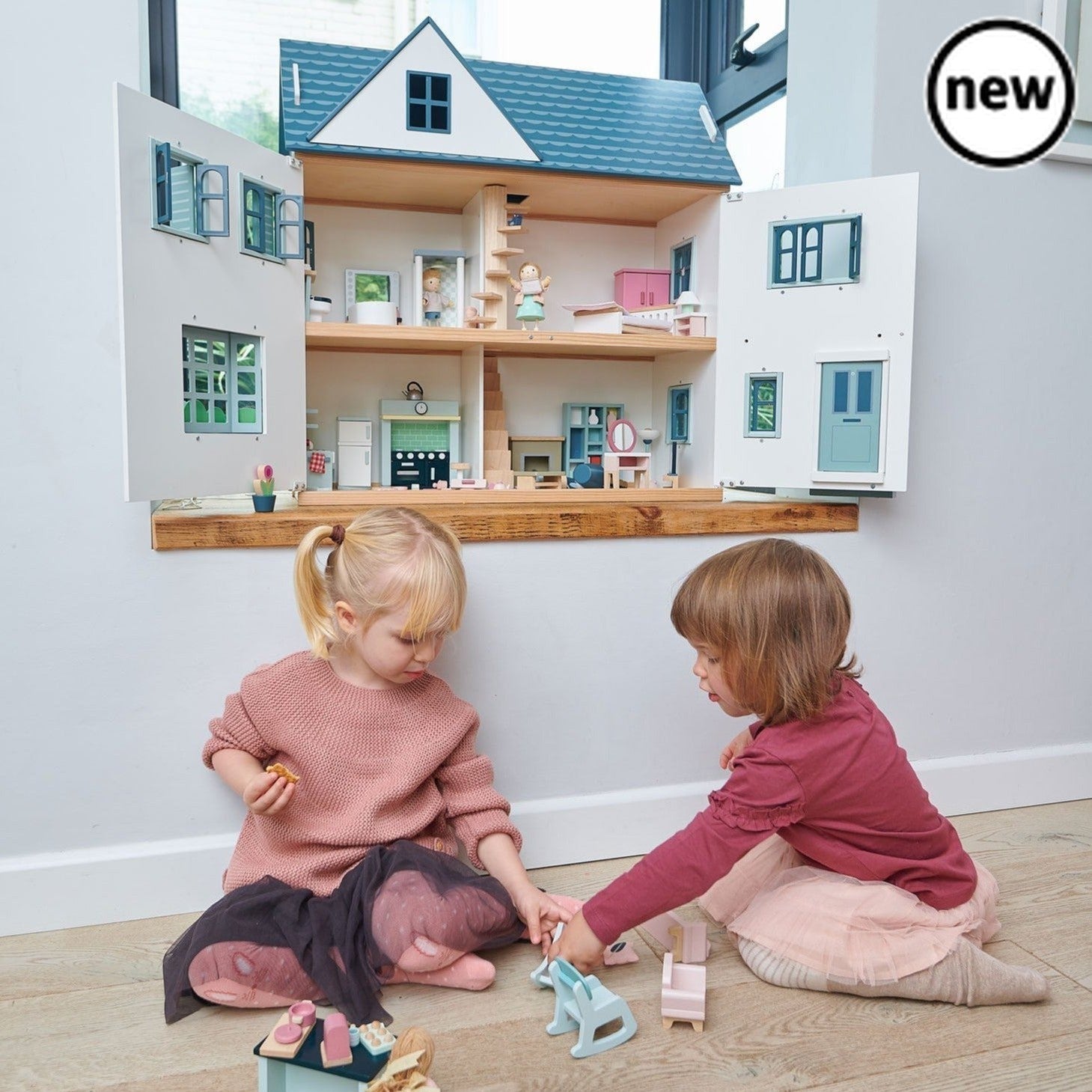 Tenderleaf Toys Dovetail House, Introducing the Tenderleaf Toys Dovetail House - a large and spacious dolls house that exudes style and charm. This stunning playset features six rooms, providing ample space for imaginative play and creativity.Designed with meticulous attention to detail, the Dovetail House boasts beautiful printed plywood floors that add a touch of elegance to its overall appeal. The gender-neutral colors make this dolls house suitable for both boys and girls, encouraging inclusive play and