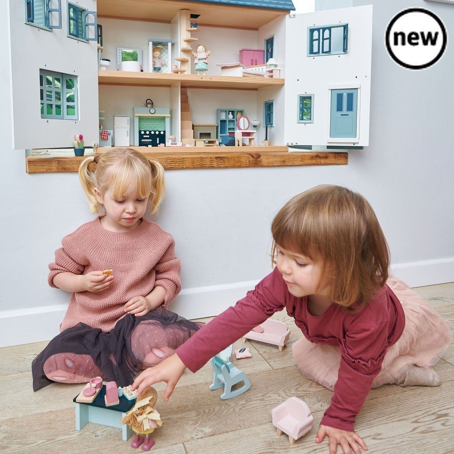 Tenderleaf Toys Dovetail House, Introducing the Tenderleaf Toys Dovetail House - a large and spacious dolls house that exudes style and charm. This stunning playset features six rooms, providing ample space for imaginative play and creativity.Designed with meticulous attention to detail, the Dovetail House boasts beautiful printed plywood floors that add a touch of elegance to its overall appeal. The gender-neutral colors make this dolls house suitable for both boys and girls, encouraging inclusive play and