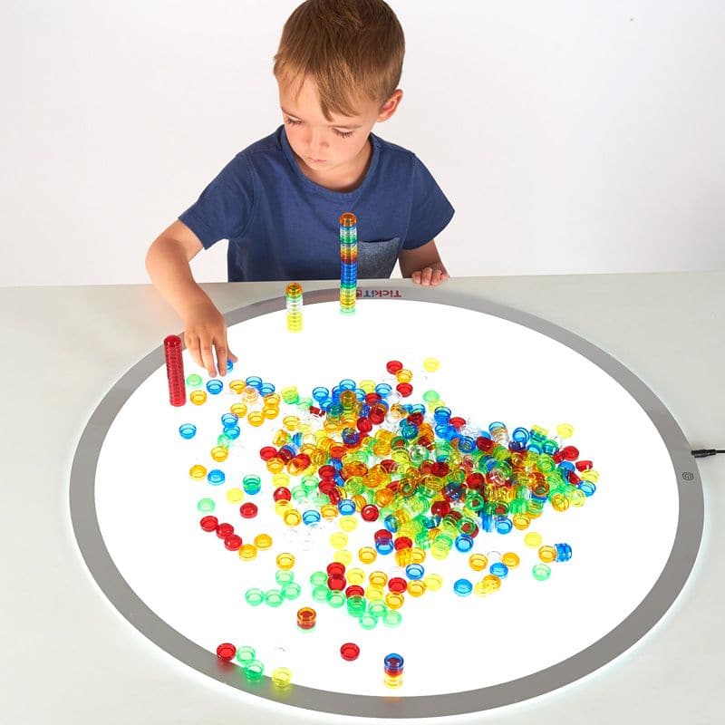 Translucent Stackable Counters 500 Piece, Translucent plastic counters in 6 colours that can be stacked into towers or used for counting, sorting, pattern-making and sequencing. The Translucent Stackable Counters come in a convenient storage container. TickiT® Translucent Stackable Counters is a set of colour acrylic counters which easily stack together so your child can create vibrant translucent towers.Perfect for use on a light panel where structures look even more impressive with the light shining throu