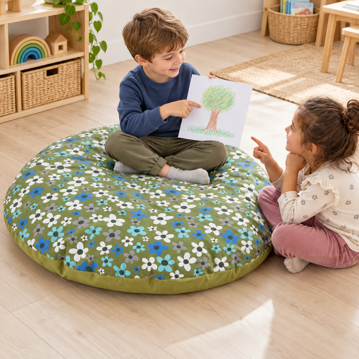 Child sharing a drawing while seated on the round floor cushion
