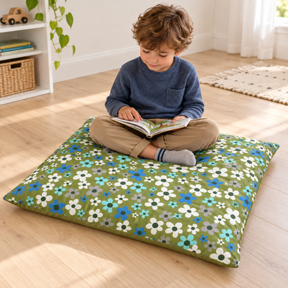 Child reading while seated on the Olive Flowers Square Floor Cushion