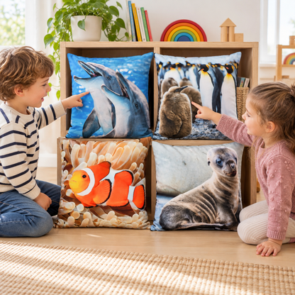 Two children comparing dolphin and penguin cushion photographs in a classroom