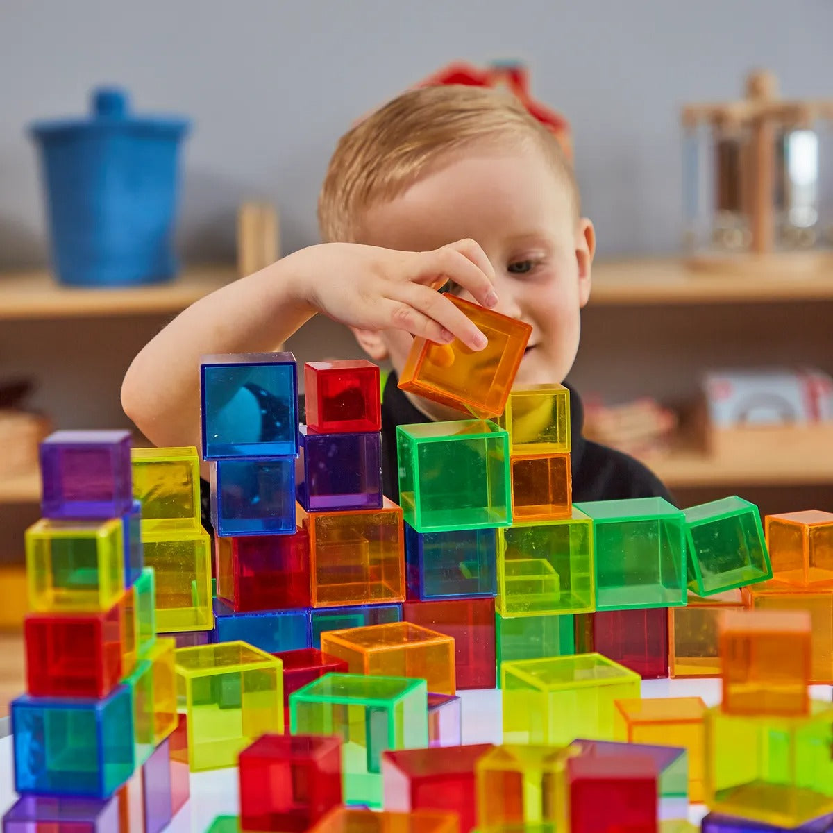 54 Pack Translucent Cube Set, An engaging alternative to traditional wooden sets, our Translucent Cubes add colours and difference to your classroom. The Translucent Cube Set are manufactured from a hardwearing but lightweight plastic, this pack of 54 Translucent cubes come in a range of bright and bold colours with flat surfaces allowing the Translucent cubes to be stacked on top of each other. Alternatively, use the Translucent cubes to educate your pupils on patterns, sequencing or general shapes with ea