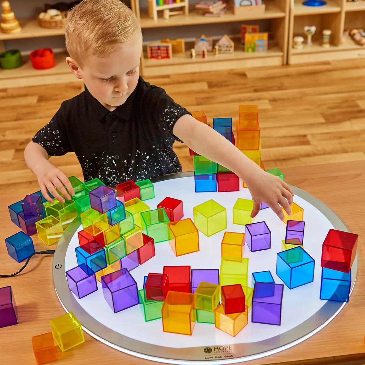 54 Pack Translucent Cube Set, An engaging alternative to traditional wooden sets, our Translucent Cubes add colours and difference to your classroom. The Translucent Cube Set are manufactured from a hardwearing but lightweight plastic, this pack of 54 Translucent cubes come in a range of bright and bold colours with flat surfaces allowing the Translucent cubes to be stacked on top of each other. Alternatively, use the Translucent cubes to educate your pupils on patterns, sequencing or general shapes with ea
