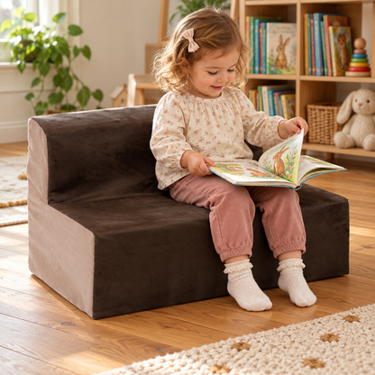 Child using 600mm wide toddler suede sofa with 200mm seat height during reading and play in a nursery