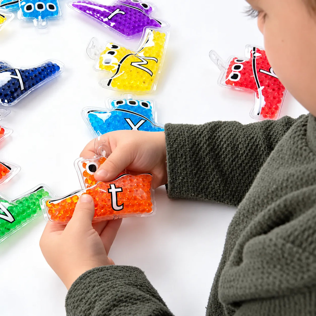 Alpha Rainbow Gel Boats Pack 26 – child exploring gel-filled alphabet boats – view 2