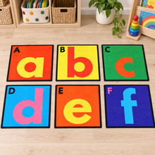 Selection of six separate Alphabet Floor Tiles showing A to F in an early years play setting