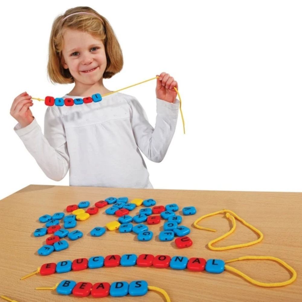 Alphabet Threading Beads, Bright and colourful chunky beads of lower and uppercase letters, Alphabet Threading Beads are perfect for reinforcing letter recognition, alphabet sequencing and spellings. Threading letter beads with vowels in red, consonants in blue and Infant Sassoon font. Beads measure 2. 5cm square. Laces measure 52cm. 4 blank yellow beads can be used to separate words and aid sentence construction. Printed with upper-case letters on one side and lower-case on the reverse. Simply flip the bea