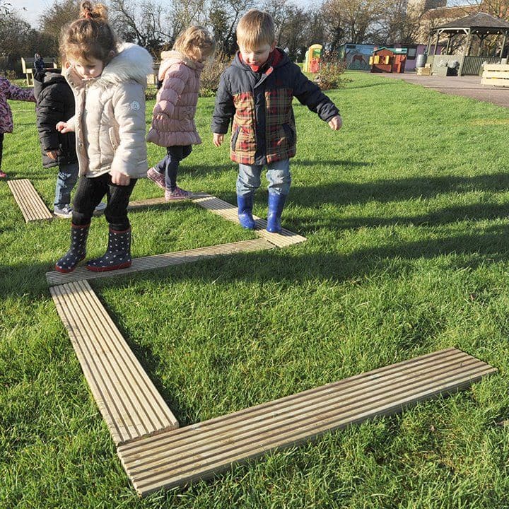Balance Planks, This a very versatile Wooden Balance Set is perfect for creating outdoor balance trails. All children love to climb and balance and now thanks to versatile balance set they can develop their skills and increase the difficulty as they get older and more confident. The Balance Planks set of 6 1.2m decking planks. Our Balancing Planks Set can be placed in a variety of layouts to suit your outdoor play area. A fantastic addition to any home or early years setting and encourages active play throu