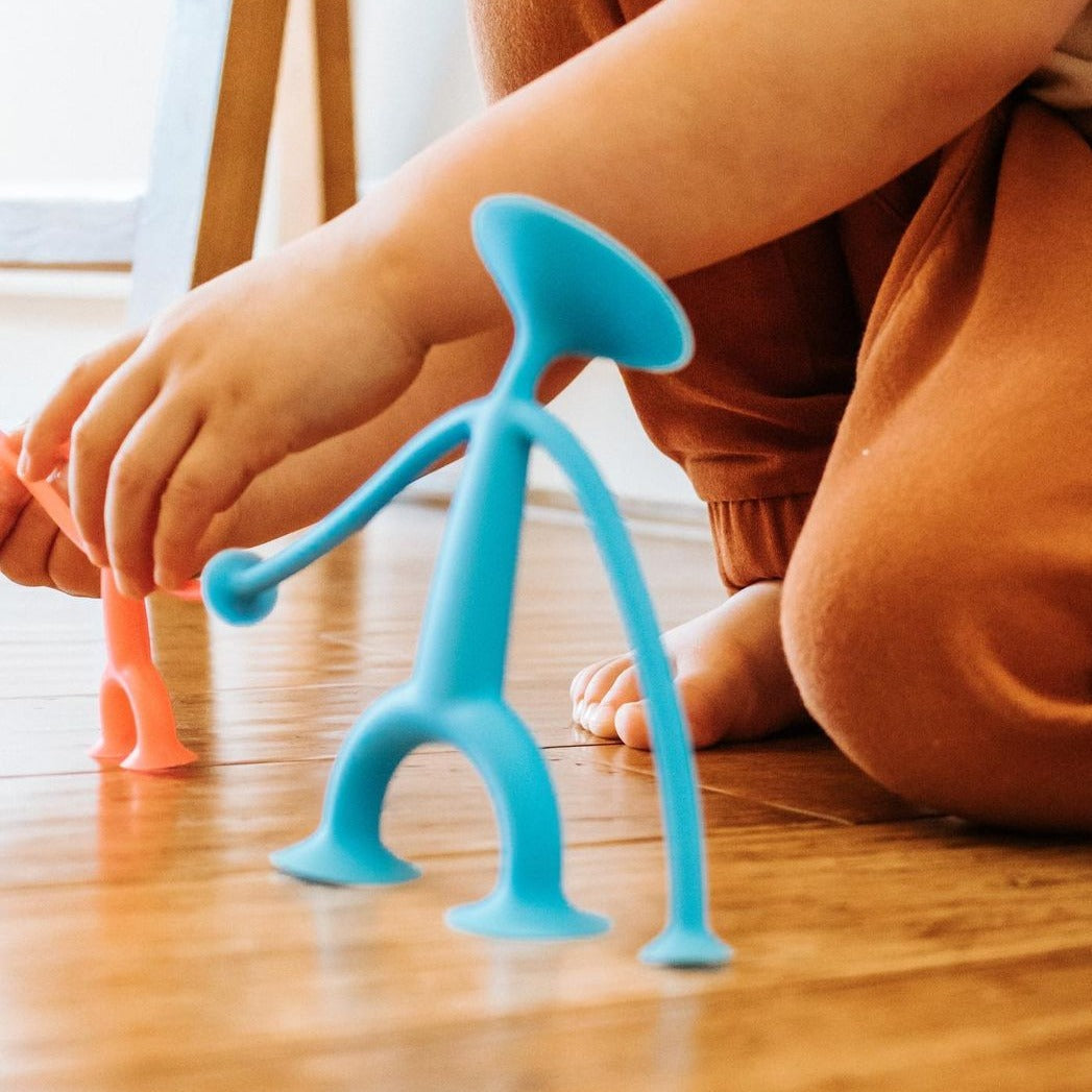 Bendy Oogi, Sticking, popping, stretching, and posing, Oogi is here to play! Bendy Oogi is made entirely of super stretchy silicone rubber and equipped with big, clinging suction cups on its head, hands, and feet, there's hardly anything this funky friend can't do. Bend it any which way you can imagine. Stick it to any smooth surface. Give it a big pull, stretch its arms wide, and listen to its suction cups pop! It comes from well, no one really knows where it came from, but it's here to pop into fun, inspi