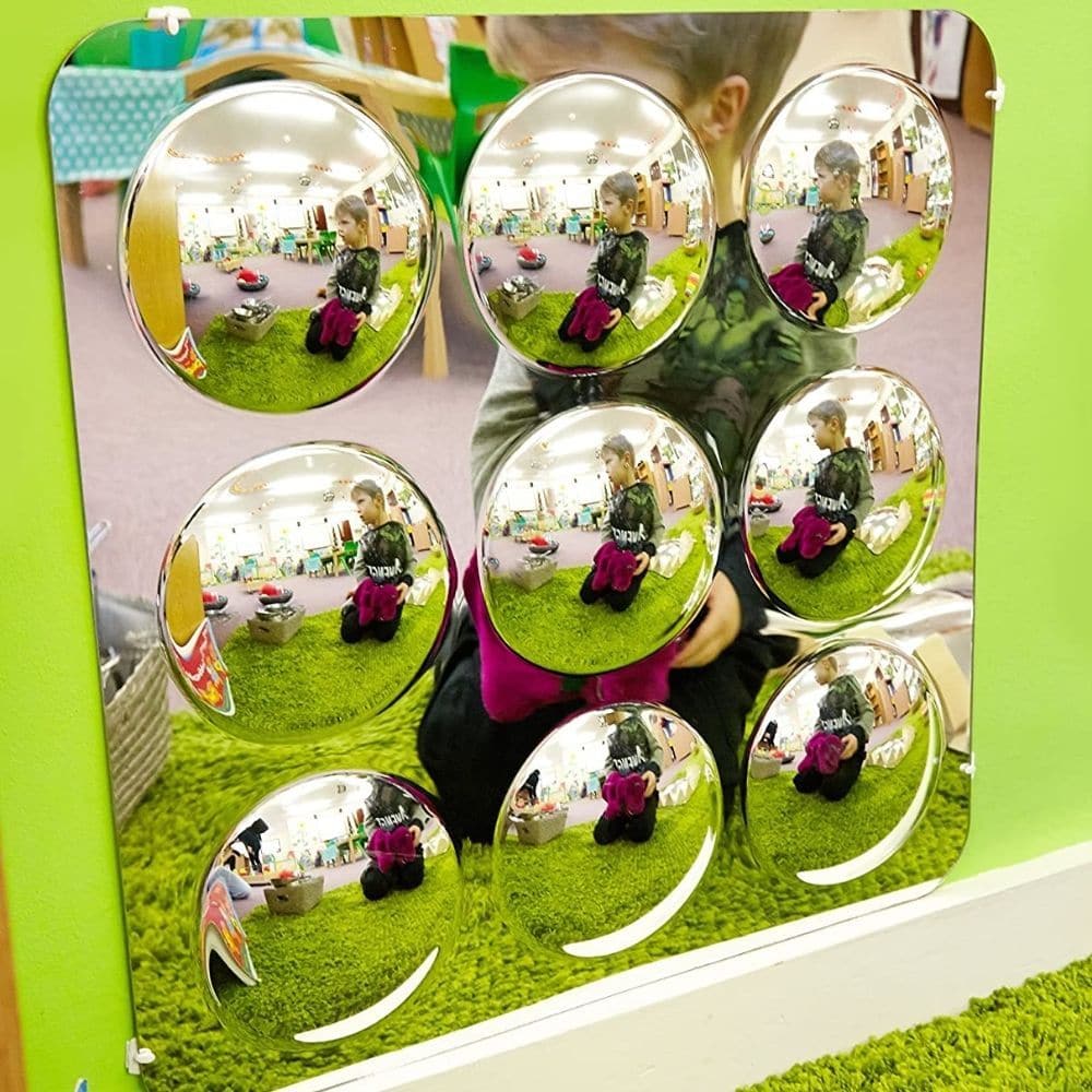 Bubble Mirror 9 Bubbles, The 9 bubble mirror is an original premium quality product designed for the school environment. 9 fascinating convex bubbles scatter light and reflections. Mount in ones or twos or more to create a stunning visual effect using the Bubble mirrors. Excellent as a pair in the corner of the room. The 9 Bubble mirror can be used outdoors if safely wall mounted. Strong moulded safety mirror, with excellent optical quality. The 9 bubble mirror also comes with self adhesive mounting pads in