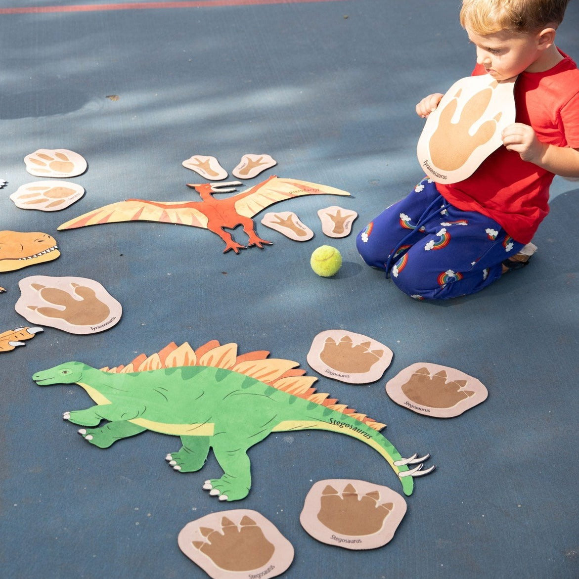 Chasing Dinosaurs, Introduce your little ones to the fascinating world of dinosaurs with our Dinosaur Footprint Trailset! This exciting playmat set features 20 non-slip, thick, natural rubber backed mats that come in various sizes, from 78cm for the largest piece to 13cm for the smallest piece. Each mat displays a colourful footprint of a different dinosaur including the Pterodactyl, Stegosaurus, Triceratops and Tyrannosaurus Rex, which makes learning fun and engaging.The Chasing Dinosaurs mats are also con