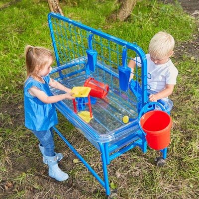 Children's Clear Water Tray with Activity Rack, The strong purpose-moulded tray sits in a blue tubular steel frame with lockable casters to allow easy movement. A sturdy lid with holes for lifting is provided to keep the contents clean and the drain plug allows easy emptying. The activity rack is designed to fit securely on the back of the water tray. It has a wire grid for threading pipes or tubes, as well as hooks on the side and the top to hang buckets, jugs, watering cans, and spray bottles. Tray size: 