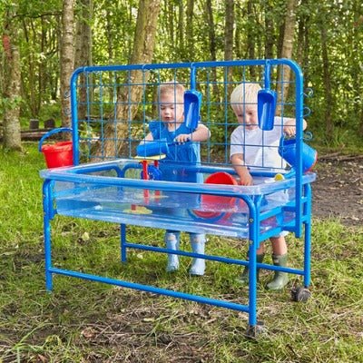 Children's Clear Water Tray with Activity Rack, The strong purpose-moulded tray sits in a blue tubular steel frame with lockable casters to allow easy movement. A sturdy lid with holes for lifting is provided to keep the contents clean and the drain plug allows easy emptying. The activity rack is designed to fit securely on the back of the water tray. It has a wire grid for threading pipes or tubes, as well as hooks on the side and the top to hang buckets, jugs, watering cans, and spray bottles. Tray size: 