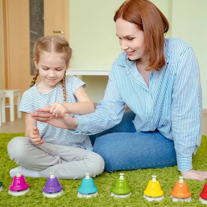 Chubby Rainbow Bells, Introducing the Chubby Rainbow Desk Bells – a vibrant and harmonious blend of colours and notes designed specifically for children. Each bell, distinct in colour, represents one note from the middle C octave, spanning from C to C. But that's not all! To make playing even more intuitive, each of these bells is thoughtfully numbered. This means a single child can align them in order and create a melody, or a group of kids can come together, each holding a bell, orchestrating a symphony o