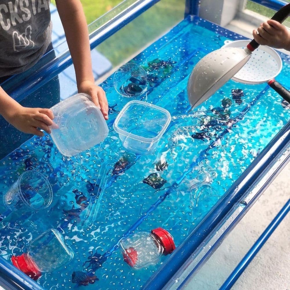 Clear Water Tray and Stand 58cm, The 58cm Clear Water Play Table: A Versatile and Interactive Play Resource The 58cm Clear Water Play Table is a fantastic addition to any early childhood learning environment. It offers a wide range of benefits for young learners and educators. Here are some key features and advantages of this play table: 1. Generous Size: With a spacious tray size of 110 x 60.5 x 21.5cm, this play table provides ample space for children to explore and engage in sensory water play activities