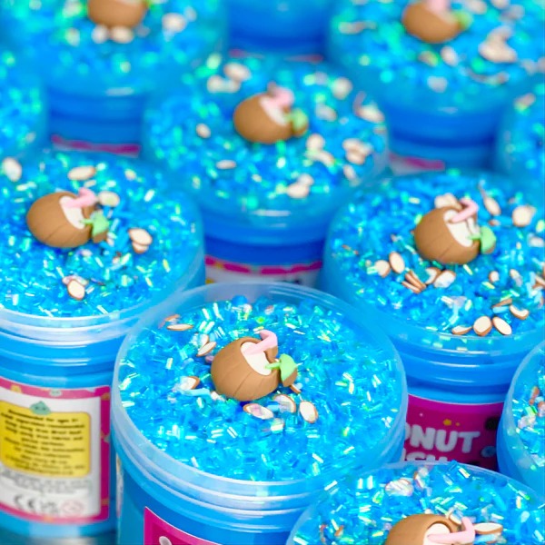 Coconut Crush Putty, Our Coconut Crush putty is like a holiday in a jar! The duo of vivid blue putty, topped with shimmering blue bingsu beads, coconut themed sprinkles and a lush coconut charm, make for a sensory, tropical paradise in your own home! Putties are air reactive and will dry out of left out. Always return to the container after play with the lid tightly on. Keep away from direct sunlight. Keep away from fabrics and porous surfaces. Container Size: 275ml Ages 5+, Adult supervision recommended. C