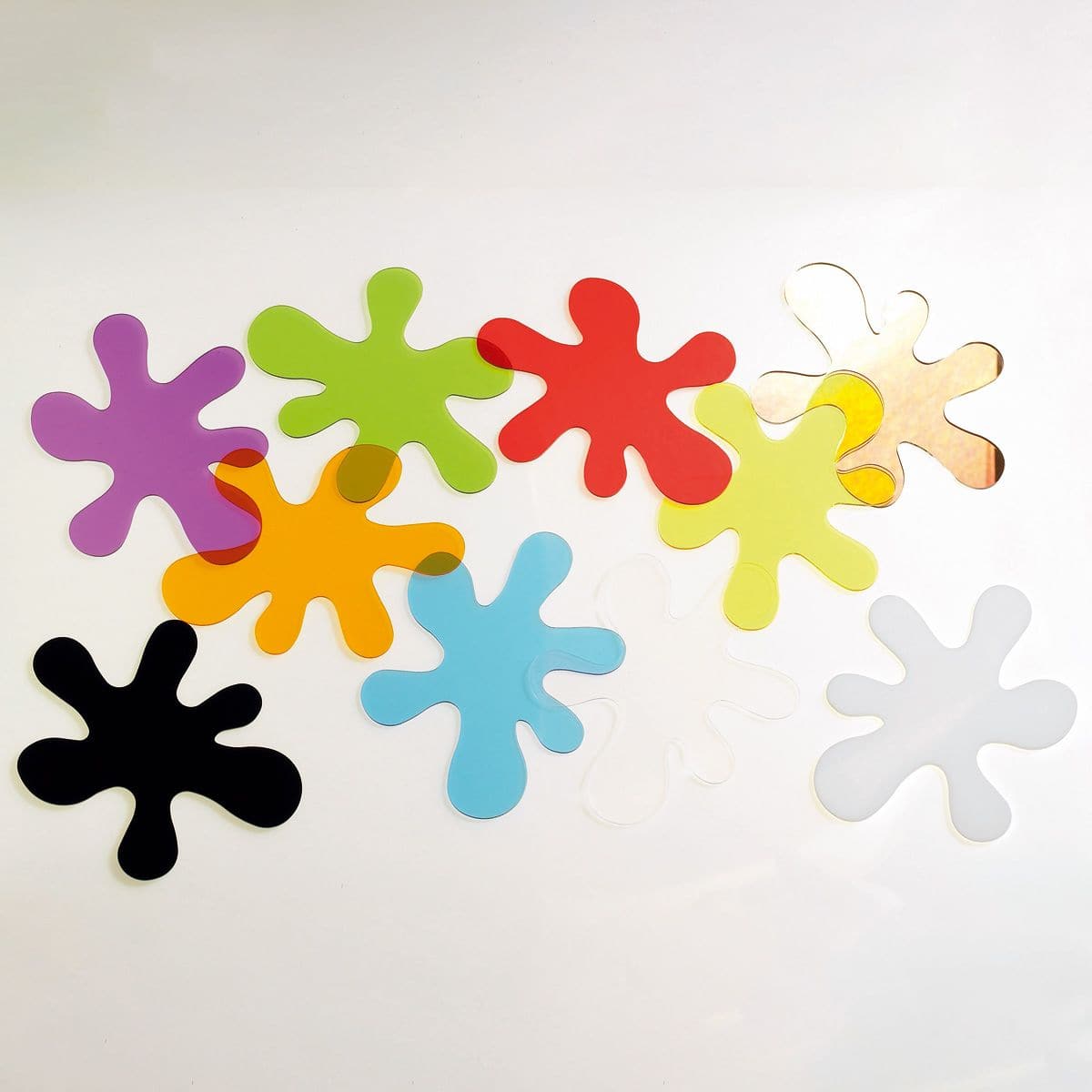 Colour Mixing Splats, The Colour Mixing Splats are colourful transparent and opaque acrylic pieces in the shape of a ‘dropped paint splat’ made in the primary and secondary colours (red, blue, yellow, green, orange and purple) as well as clear, black and white and double sided mirrored (black, white and mirrored are opaque). The Colour Mixing Splats can be used on their own or on a light box, for colour mixing, matching, light observation, shadow making and for wall decoration near to the painting area. Ide