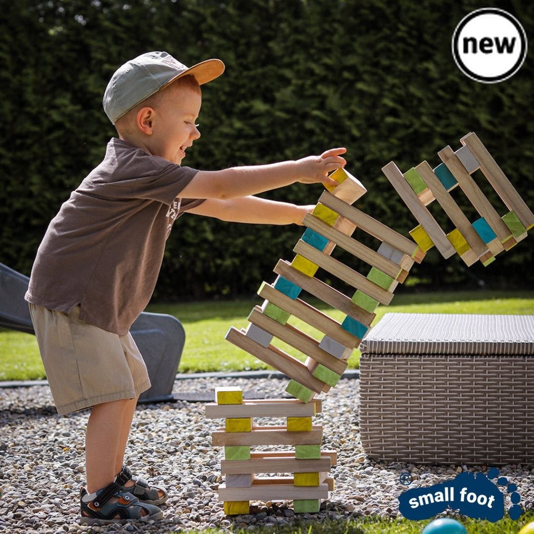 Colourful Wobbly Tower, Introducing our Colourful Wobbly Tower, the game that will make your hands shake and your heart race! This 60-piece dexterity game, made with FSC® 100%-certified wood, is perfect for outdoor playtime. The objective is simple but challenging - players must have a steady hand and carefully pull individual blocks out of the tower without causing it to topple over. What sets this game apart is the inclusion of a colored die, adding an exciting twist to the gameplay. The die determines wh