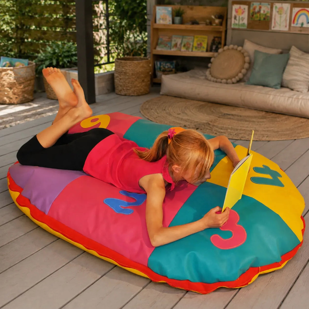 Cosy Oval Number Cushion with child reading in covered outdoor reading area