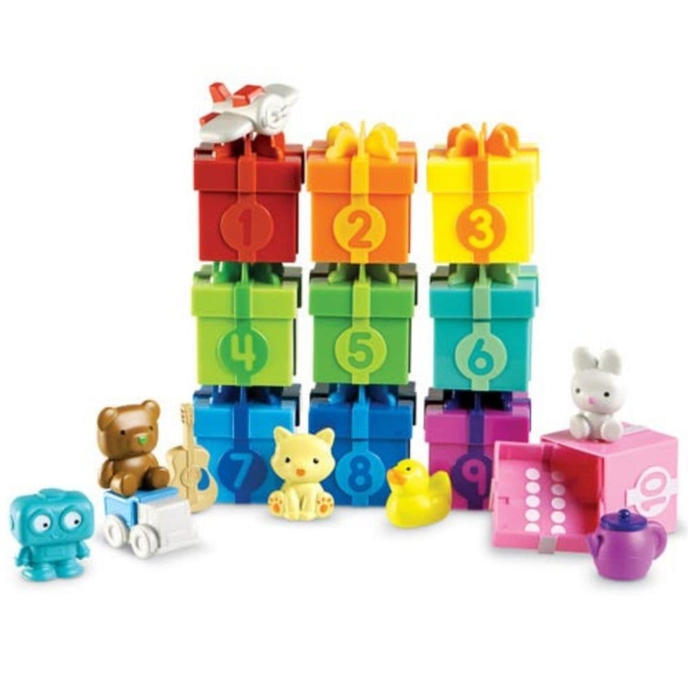 Counting Surprise Party, The Counting Surprise Party is a delightful learning toy designed to provide hours of educational fun for your child. This collection includes a range of numbered boxes, each containing a different colourful object. The boxes are adorned with numerals on the front and a dot array inside the lid, making it easy for children to match the lid to the correct numbered box. Each box is a treasure trove of fun, containing various objects from a friendly cat to a vibrant purple teapot. Thes