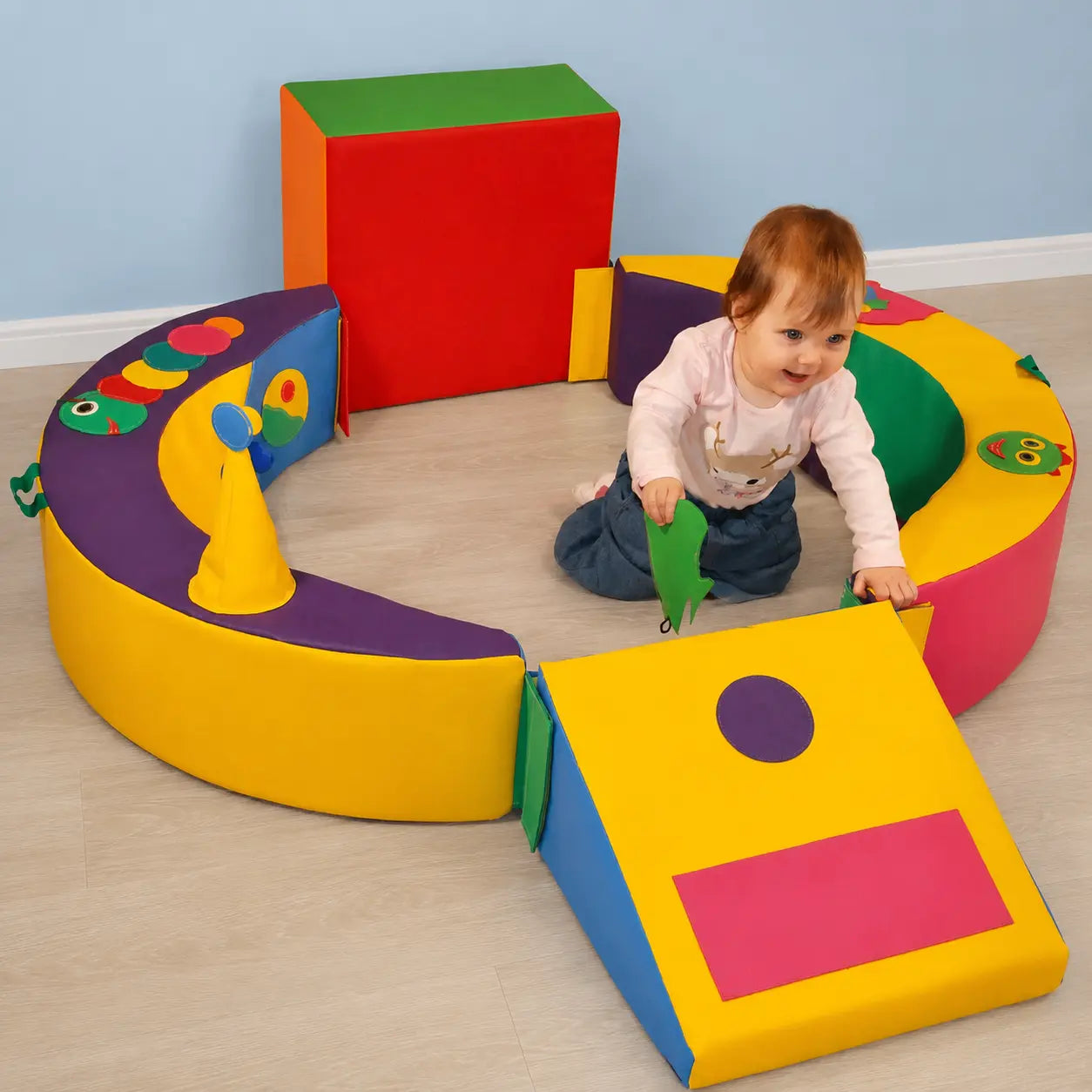 Crescent Ring Trio Exploration Set with toddler in baby play area