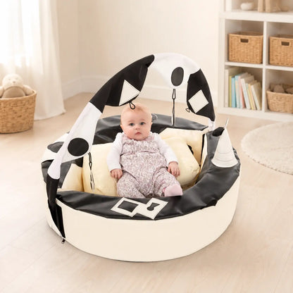 Crescent Ring with Activity Arch in a nursery reading corner with baby
