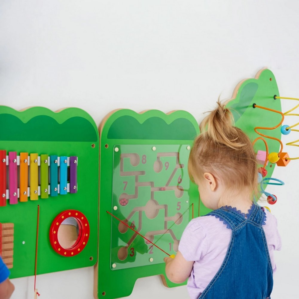 Crocodile Activity Wall Panel, The Crocodile Activity Wall Panel can be used to inspire musical exploration from 12 months. The friendly Crocodile Activity Wall Panel is visually stunning and will promote hours of interactive fun for individual children or small groups of children playing and learning collaboratively. The Crocodile Activity Wall Panel is made in five pieces, each with a different set of manipulative activities all designed to encourage hand-eye coordination and fine motor skills. Components