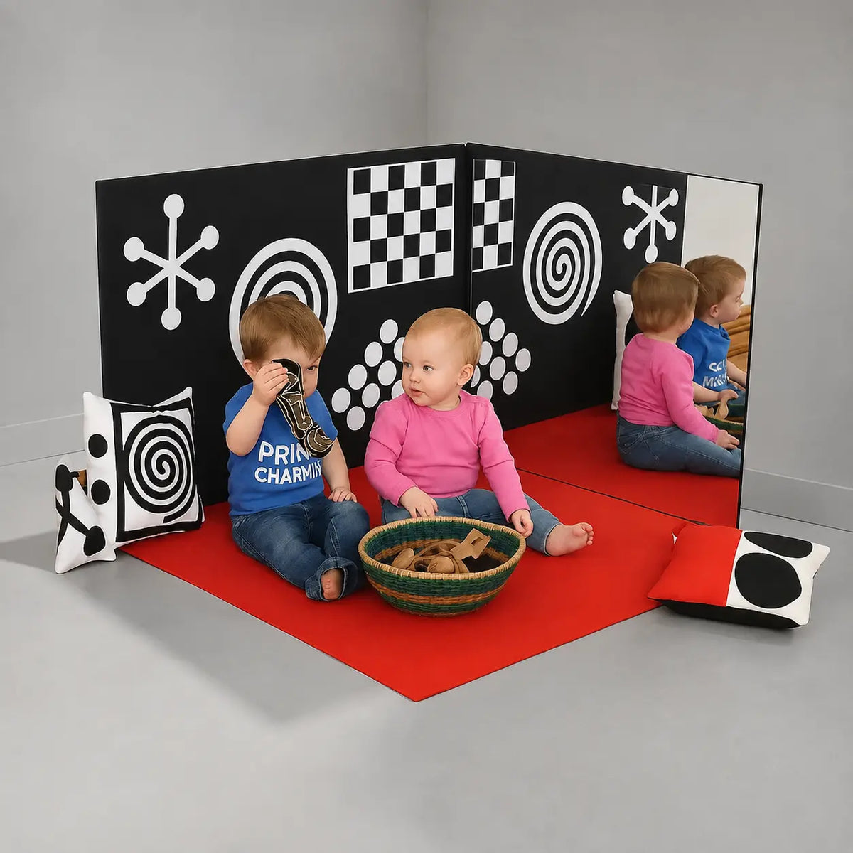 Curiosity Corner sensory panels and red play mat in a neutral studio room