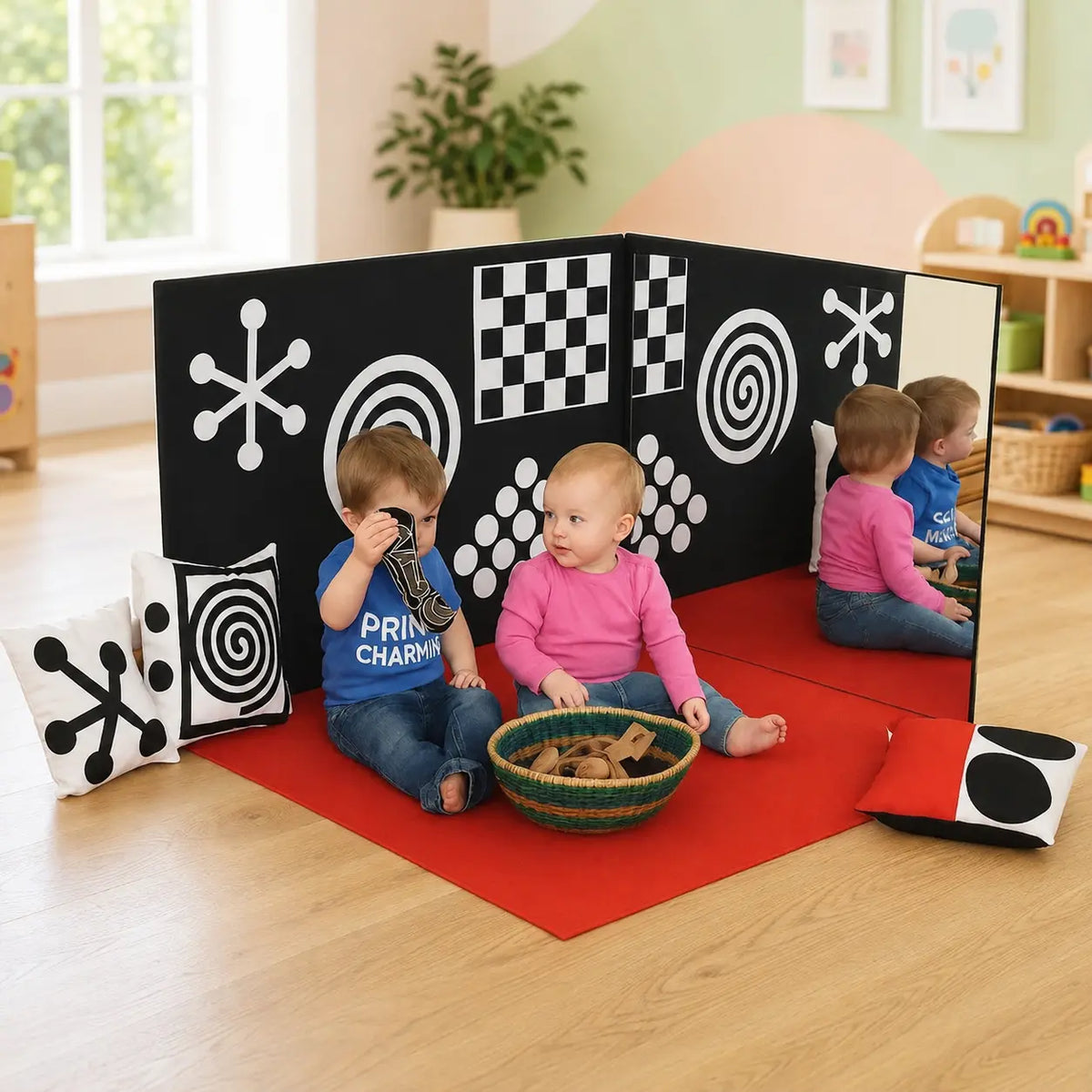 Curiosity Corner sensory panels and red play mat in a childcare playroom