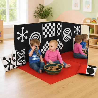Curiosity Corner sensory panels and red play mat in a childcare playroom