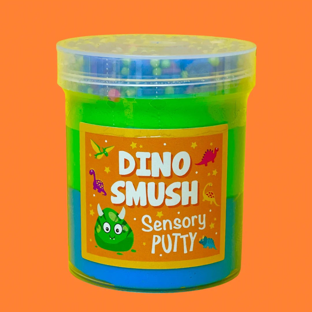 Dino Smush Putty, Our Dino Smush putty is absolutely roar-some! A duo of vibrant blue and green putty, topped with rainbow sprinkles, green and blue floam beads and an adorable dinosaur charm for all the prehistoric fun you could ever need! Putties are air reactive and will dry out of left out. Always return to the container after play with the lid tightly on. Keep away from direct sunlight. Keep away from fabrics and porous surfaces. Container Size: 275ml Ages 5+, Adult supervision recommended. Dino Smush 