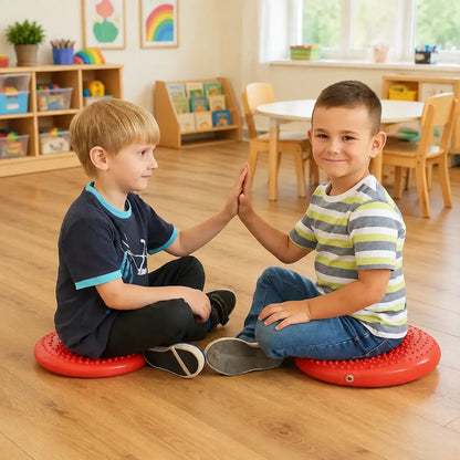Disc O Sit Junior red inflatable seating cushions used by two children in an early years classroom