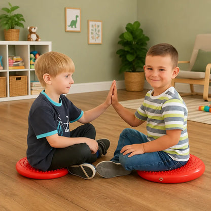 Disc O Sit Junior red inflatable seating cushions used by two children in a home playroom