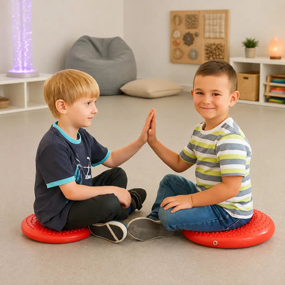 Disc O Sit Junior red inflatable seating cushions used by two children in a sensory room