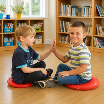 Disc O Sit Junior red inflatable seating cushions used by two children in a school library