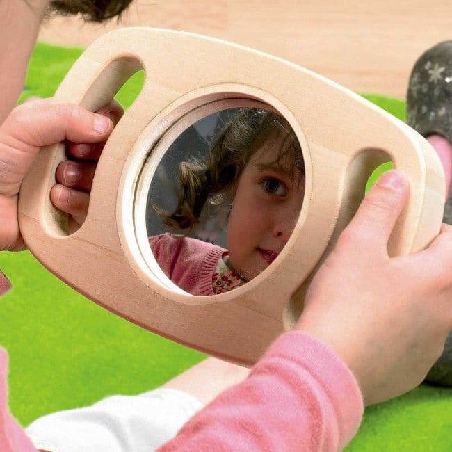 Easy Hold Convex Concave Mirror, The TickiT Easy Hold Convex/Concave Mirror is a delightful and easy to hold concave mirror. The TickiT Easy Hold Convex/Concave Mirror is a fantastically safe hand held acrylic mirror which children love to use to explore there own facial expressions and features. The TickiT Easy Hold Convex/Concave Mirror has a rubberwood frame with easy grip handles enclosing a concave and convex mirror. The TickiT Easy Hold Convex/Concave Mirror produces fascinating reflections – upside d